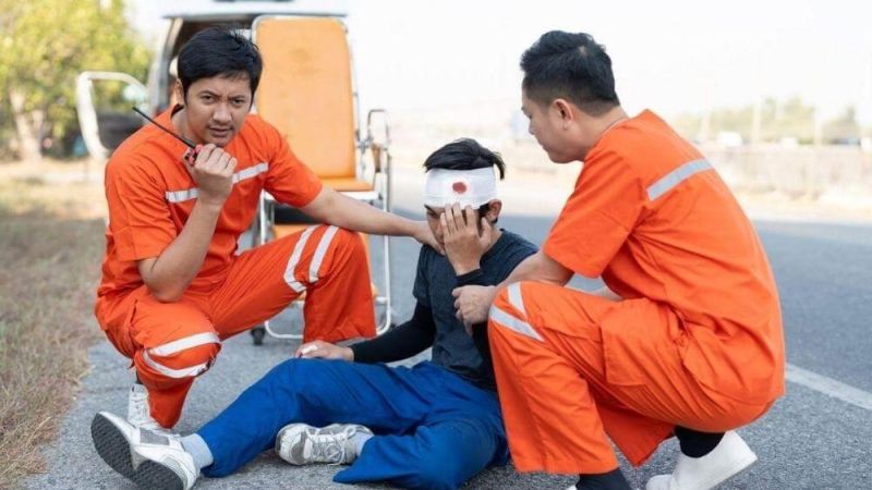Group of people in orange jumpsuits sitting