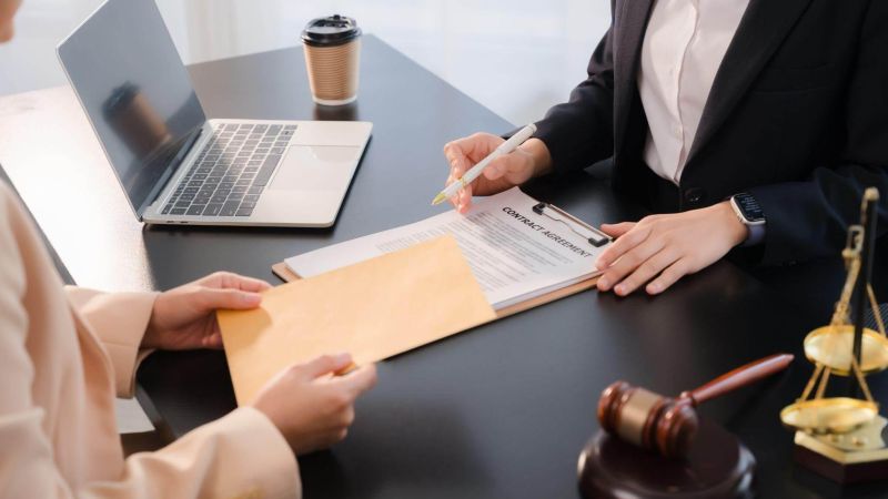 Two people review legal papers with a