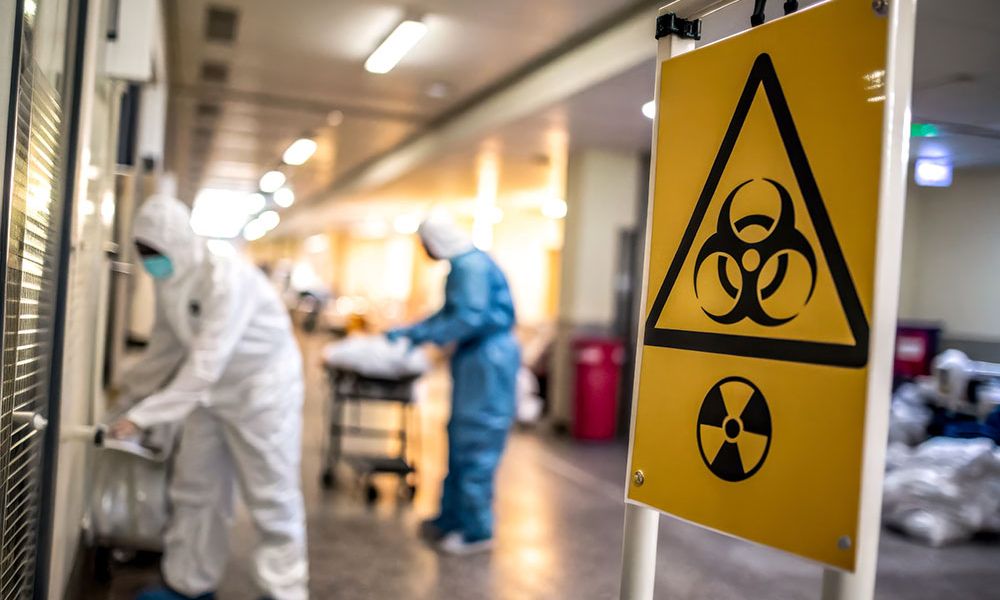 Workers in hazmat suits manage biohazardous Toxic Exposure