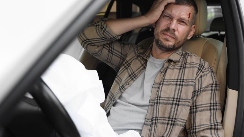 Stressed man sitting in a car