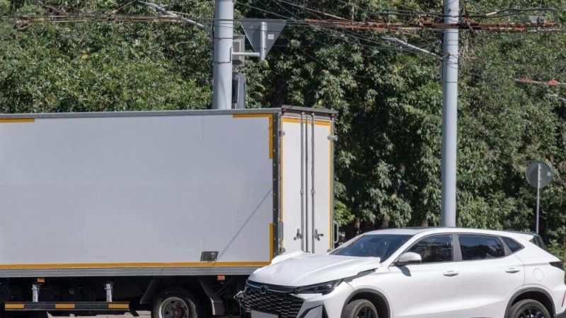 White semi-truck driving on a road next