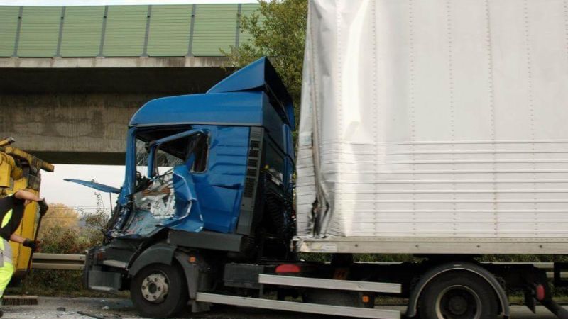 Two men standing next to a semi-truck