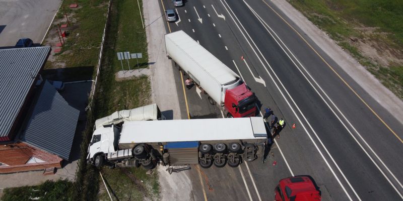 Aerial view of an overturned truck on I-81 in Virginia, surrounded by emergency response vehicles and debris.