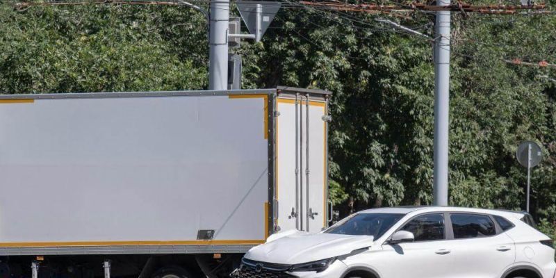White semi-truck driving on a road next