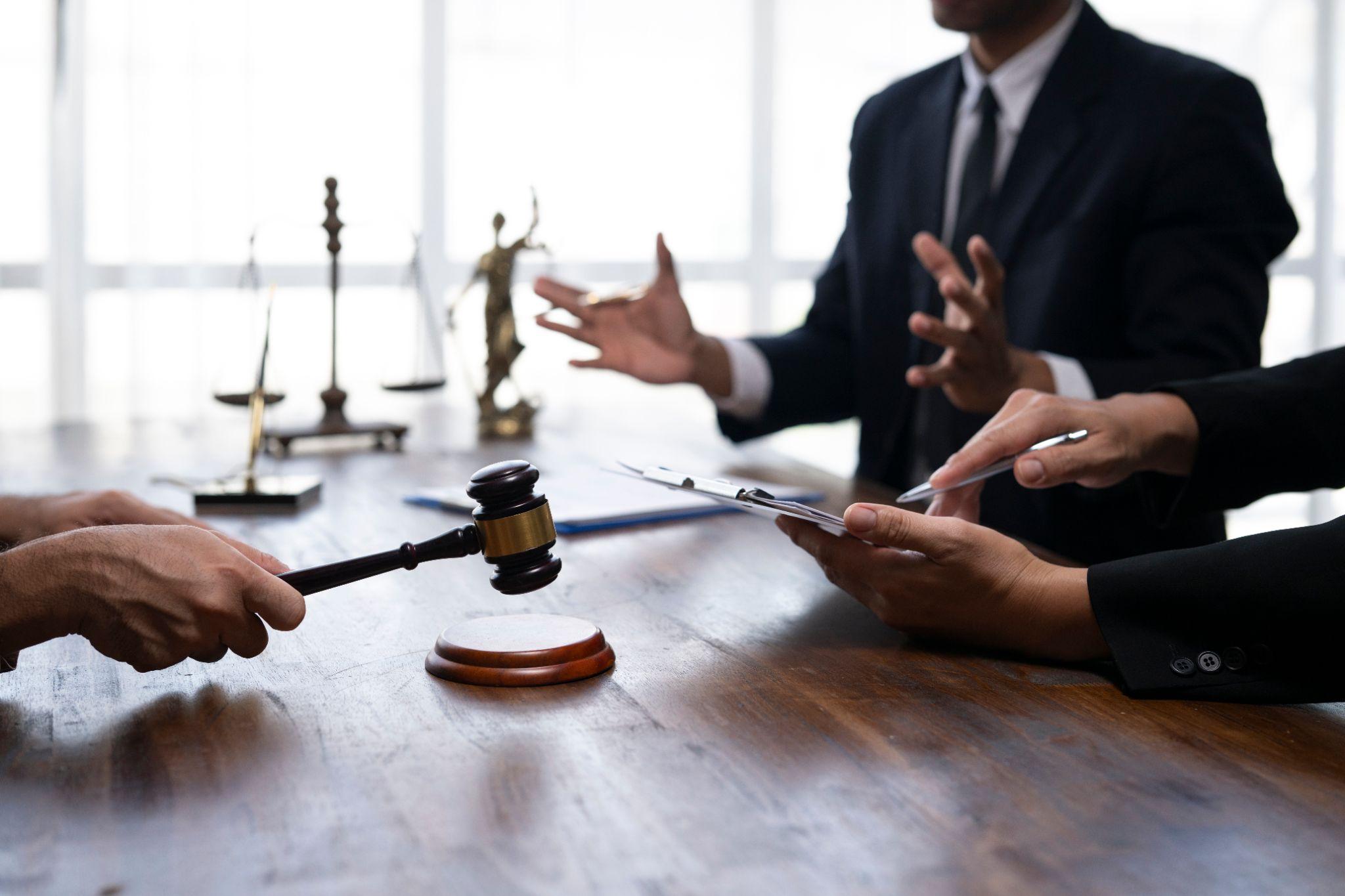 Group of people, possibly clients and legal advisors,