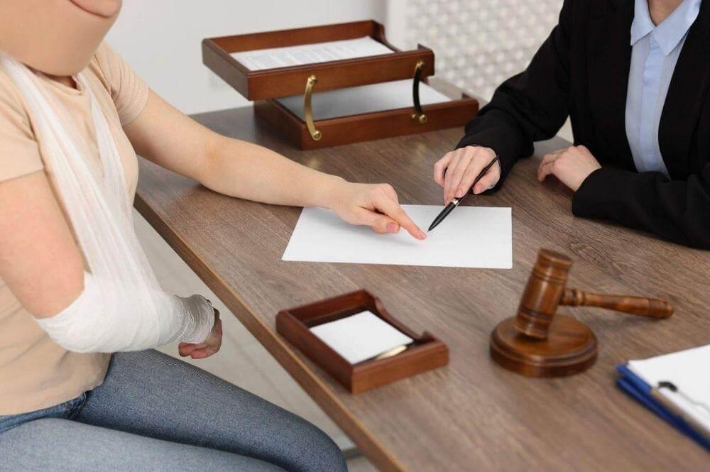 A woman discusses her personal injury settlement with a