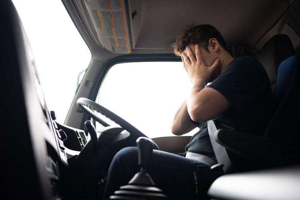 Man sitting in semi-truck driver