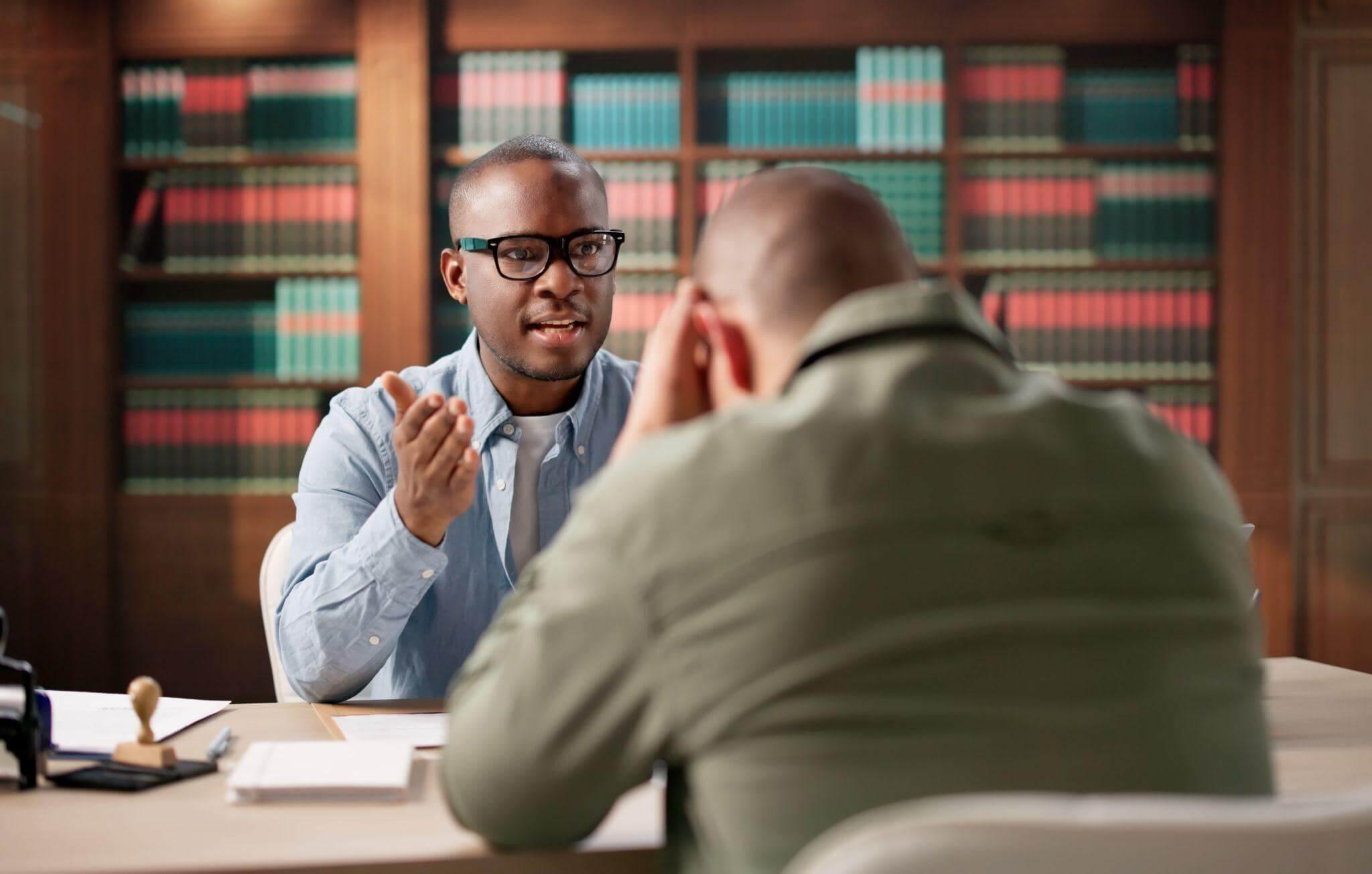 Two men discussing a wrongful death client review