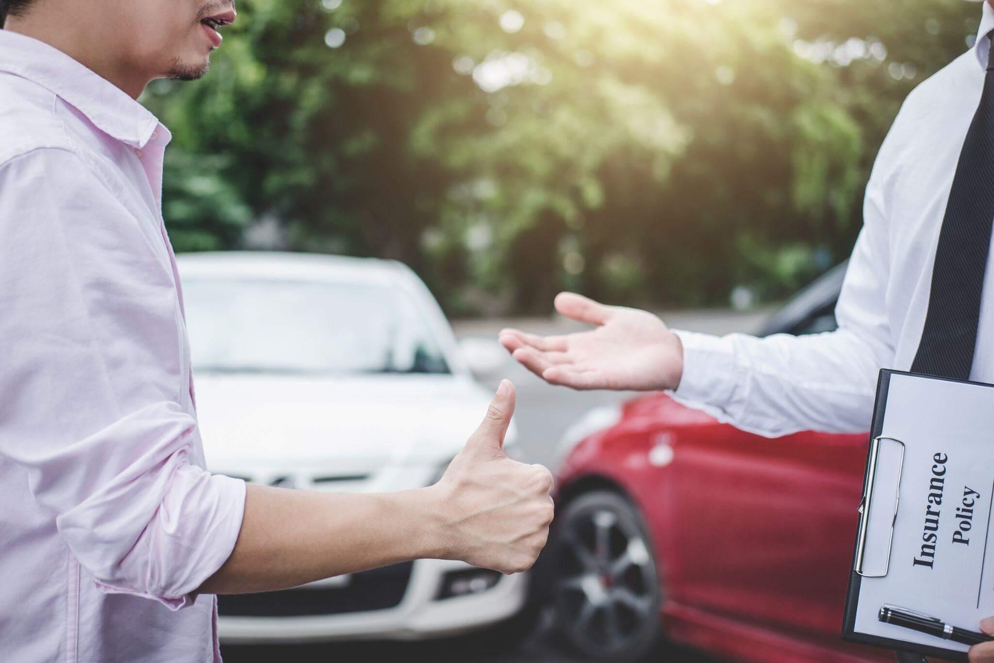 Two men discussing in a parking lot.