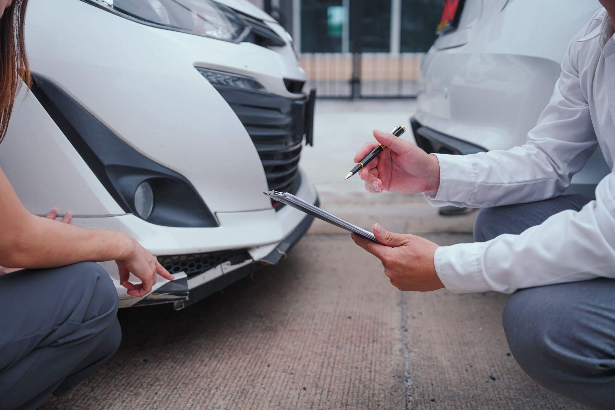 Two people review insurance documents next to