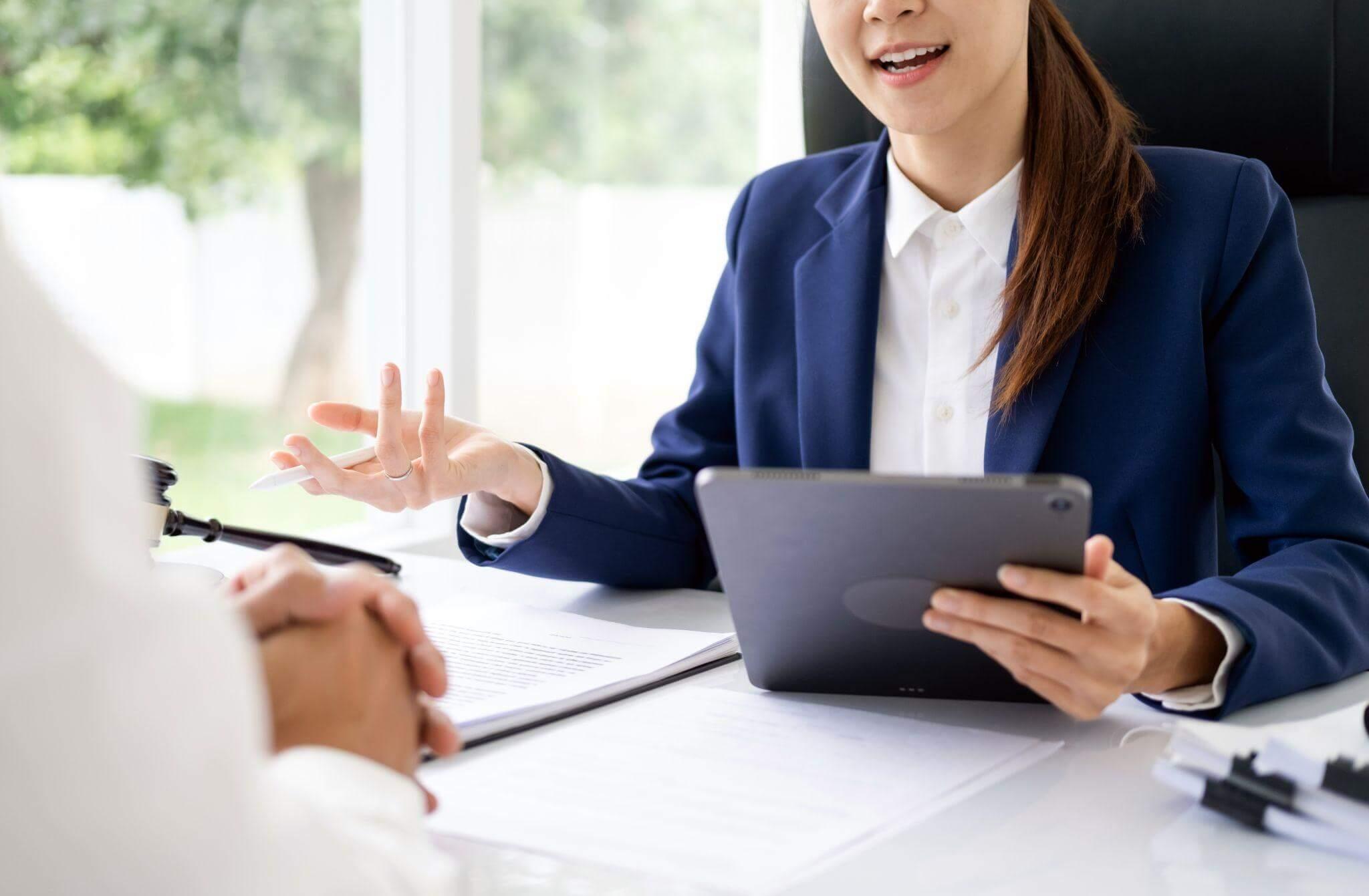 Two women discussing a wrongful death claim with legal counsel