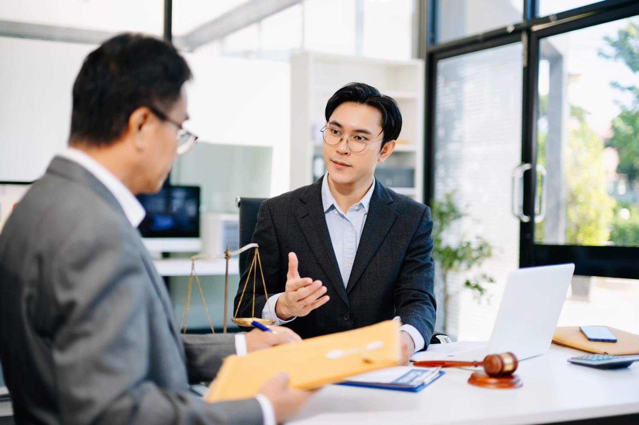 Two men in suits discussing legal action
